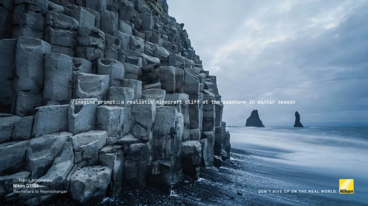 A rocky cliff on a beach
Description automatically generated
